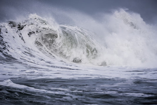 A large wave breaks on a stormy morning; Seaside, Oregon, United States of America